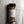 A clear plastic shaker bottle of Casa Flake Garlic and Herb Seasoning with a black lid and white label, set on a gray marble surface.