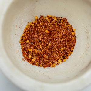 Spice blend in a white bowl on a light background