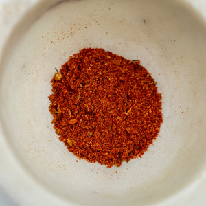 Red spice mix in a white bowl