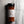 A bottle of Casa Flake KC BBQ Rub seasoning standing upright on a gray stone-textured surface. The clear bottle shows the reddish-brown spice inside, with a white label and black cap.