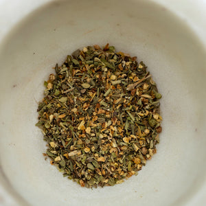 Dry herbs in a white bowl
