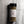 A clear plastic spice jar with a black lid and a white label reading 'CASA FLAKE' and 'LEMON ORANGE HERBS', filled with dried greenish-brown herbs, photographed on a gray marble-like surface.