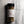 A clear plastic spice jar of Casa Flake Pizza Seasoning with a black lid and white label, set against a gray marble background.