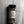 A clear plastic spice jar of Casa Flake Roasted Garlic Pepper with a black lid and white label, set against a gray marble-textured background.