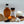 Spices, herbs, and a bottle of syrup on a wooden board with a white background