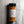 A clear plastic spice jar filled with orange-brown seasoning powder, topped with a black lid and labeled 'CASA FLAKE SWEET BUFFALO SEASONING,' set against a gray stone-textured background.