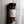 A clear plastic spice jar of Casa Flake Wild Ember seasoning with a black lid and white label, set against a gray marble background.