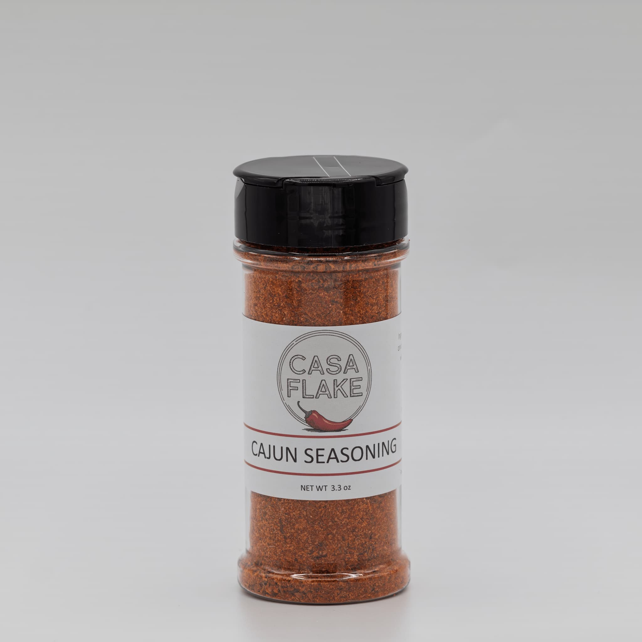 Bottle of Casa Flake Cajun Seasoning on a gray background