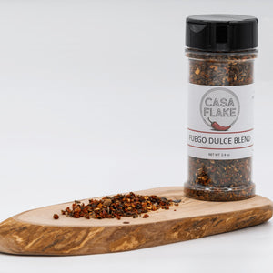 Casa Flake Fuego Dulce Blend spice jar on a wooden board with a white background