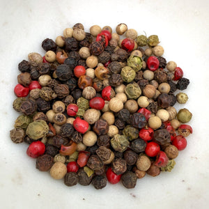 Casa Flake Gourmet Peppercorn Mixer peppercorns including black, white, red, and green on a white background