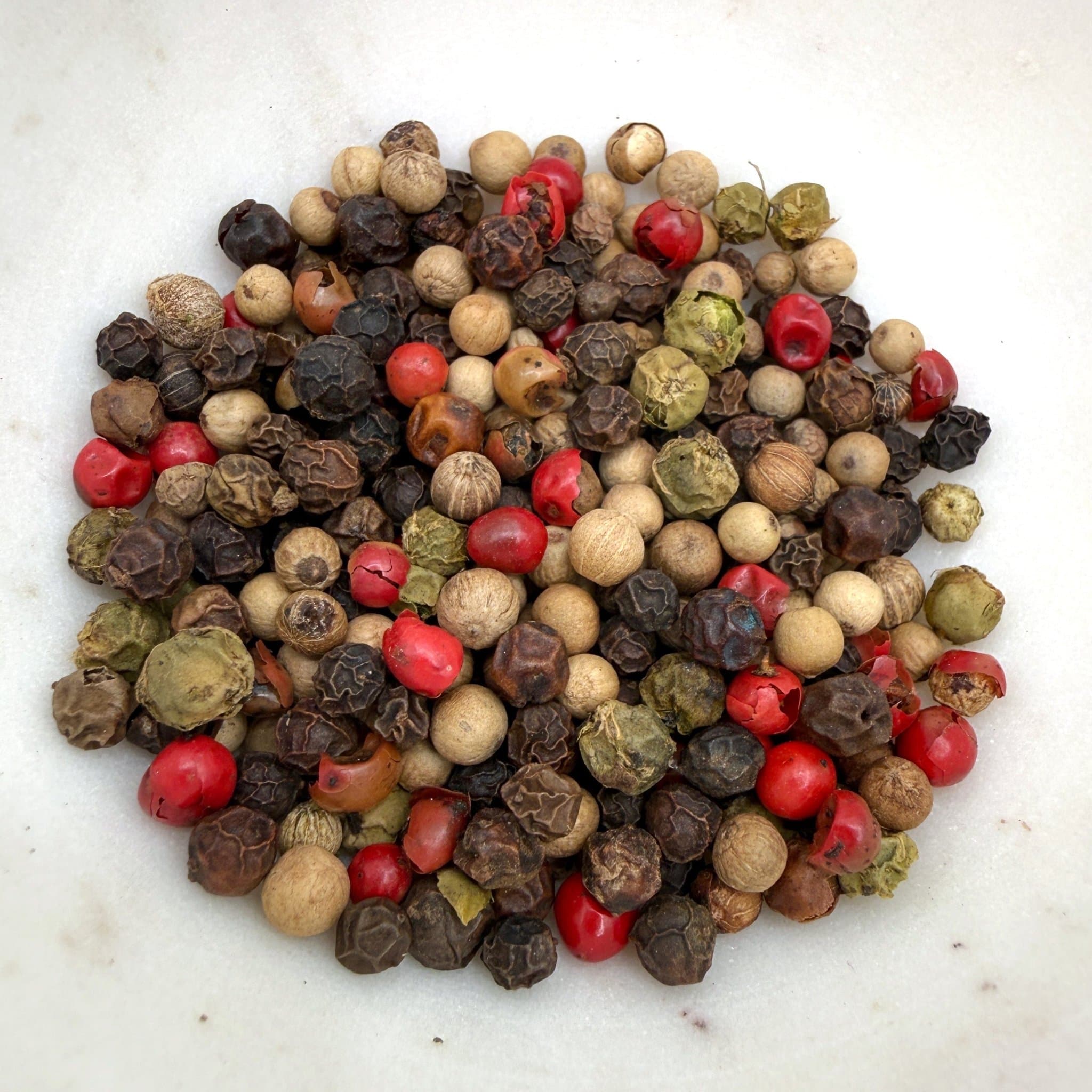 Casa Flake Gourmet Peppercorn Mixer peppercorns including black, white, red, and green on a white background