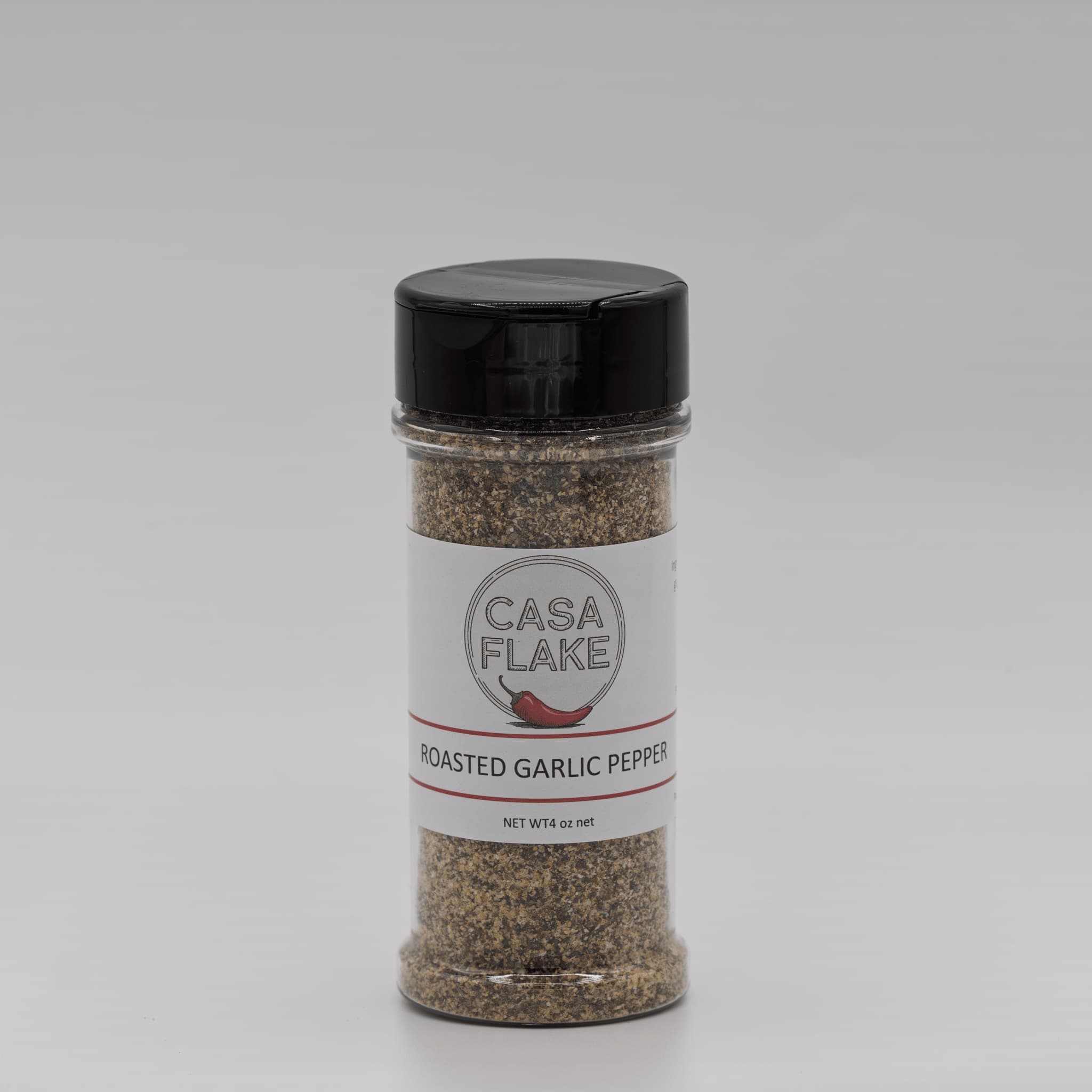 Bottle of Casa Flake Roasted Garlic Pepper on a gray background