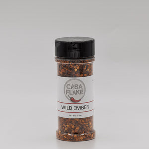 Bottle of Casa Flake Wild Ember seasoning on a gray background